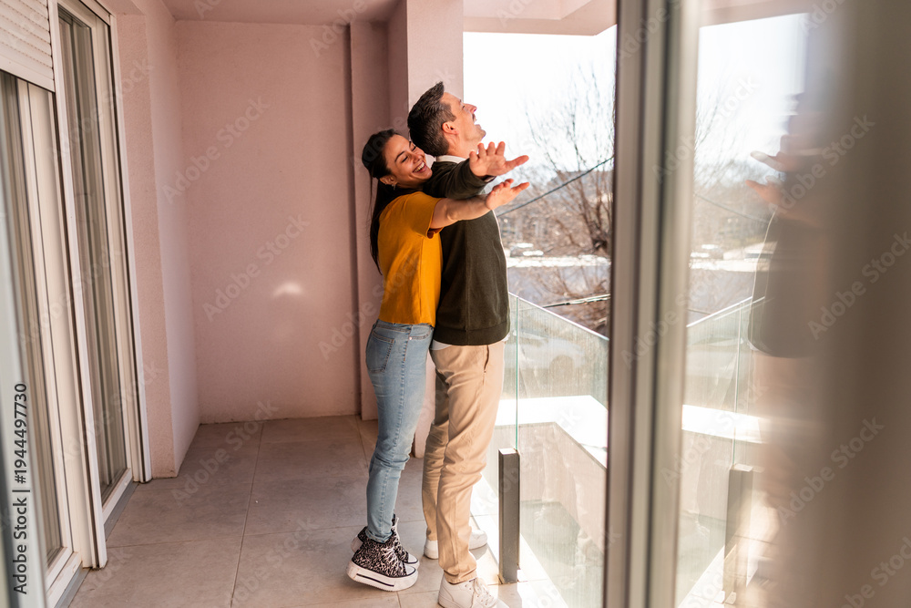 Fototapeta premium Young Couple Embracing On Balcony