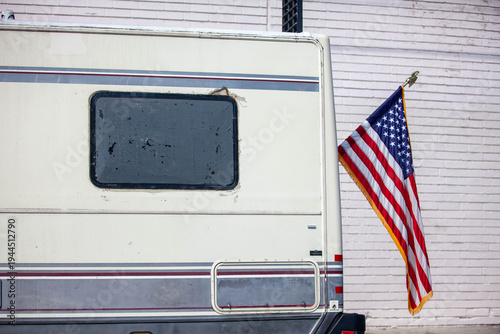 Clean American flag on a battered RV