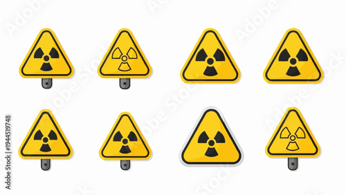 Eight yellow triangular radiation hazard warning signs with black symbols on white background