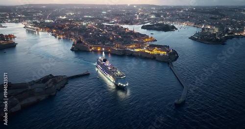 Malta, Valletta - 11.10.2025: Cruise luminous ship leaves the port of Valletta at night. Malta 