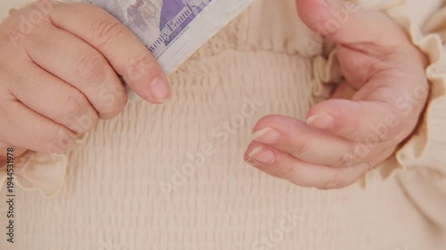 Close-up female hands counting uk pounds bills, paper money, British GBP banknotes, Bank of England currency, Money Management Accuracy, salary, payments fund, financial freedom, save up for vacation
