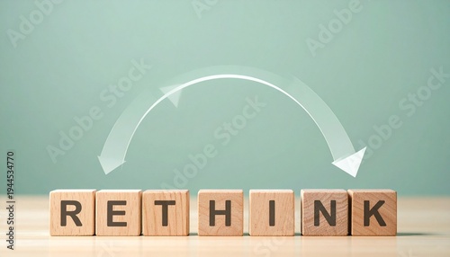 Conceptual Image of Wooden Blocks Spelling the Word Rethink with a Curved Arrow Symbolizing a Change in Perspective Mindset Shift and Problem Solving Strategy in Business or Education