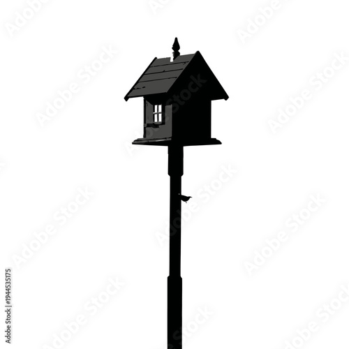 Silhouette of a small, dark birdhouse mounted on a tall pole against a white background.