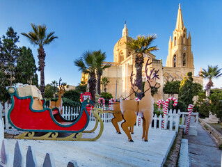 Christmas decoration with sleigh and reindeer in front of the Parish Church in Ghajnsielem, Gozo