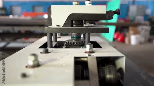 Differential gears in an industrial machine turn slowly while producing a steady metallic sound. The gears mesh together, showcasing the inner workings of machinery.