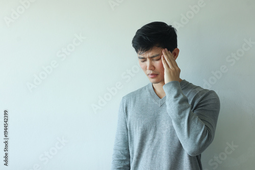 close up young asian man massage on head after feel stress symptom or migraine for unhealthy lifestyle concept