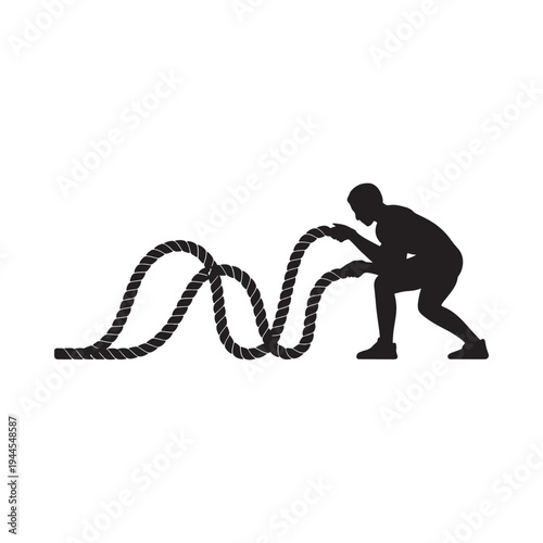 Silhouette of an athlete vigorously training with a thick battle rope