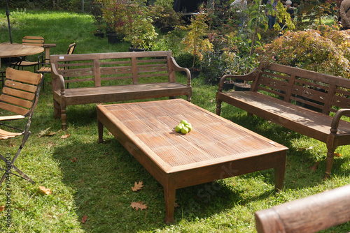 Wooden garden furniture set table and bench on lawn patio outdoor seating arrangement