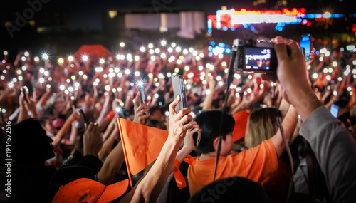 Supporters of the People's Party (Phak Prachachon) holding phone lights and orange flags at a night campaign rally in Thailand, ahead of the general election on February 8, 2026.