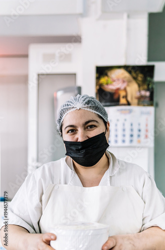 Fotografie Food worker wearing face mask and hairnet