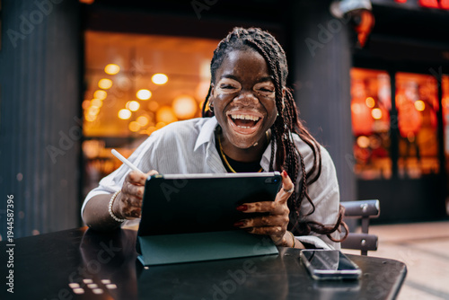 Quadro em tela Portrait of cheerful African American female student using tablet with electroni