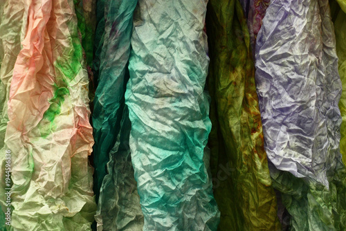 Bright colorful abstract image. Several multi-colored scarfs from natural silk.