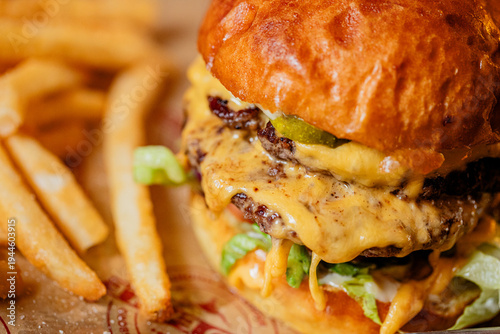 Cuadro en lienzo A double cheeseburger with french fries at a modern American restaurant