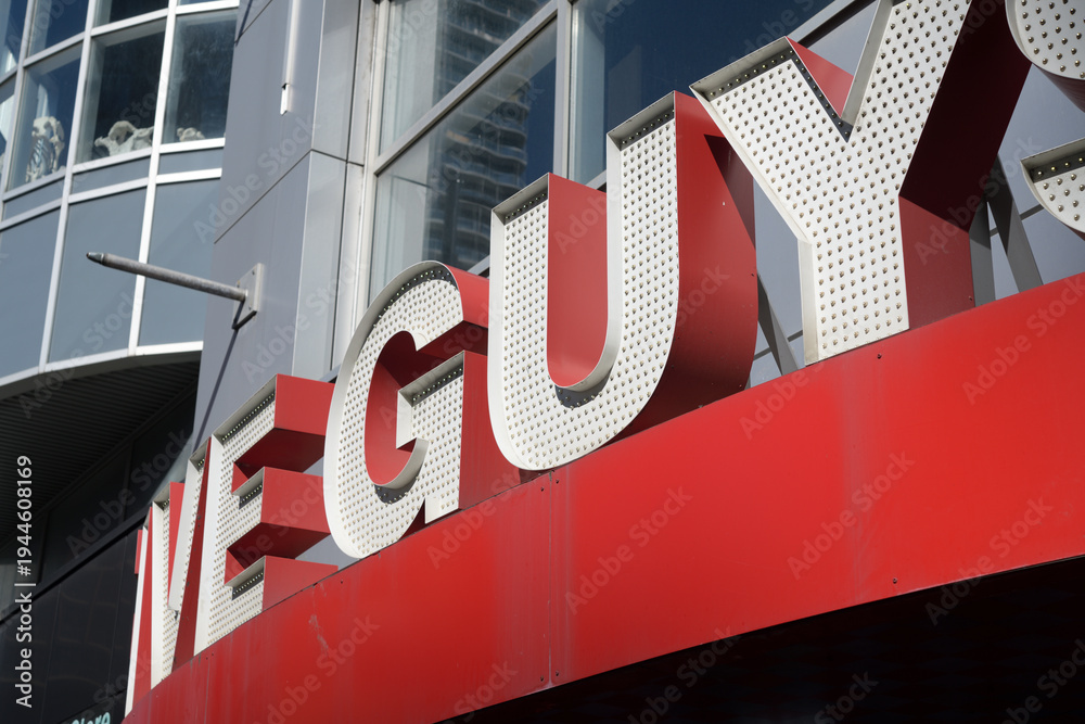 Obraz premium close-up of sign on the front of Five Guys, a fast food restaurant, located here at 329 Yonge St, Toronto