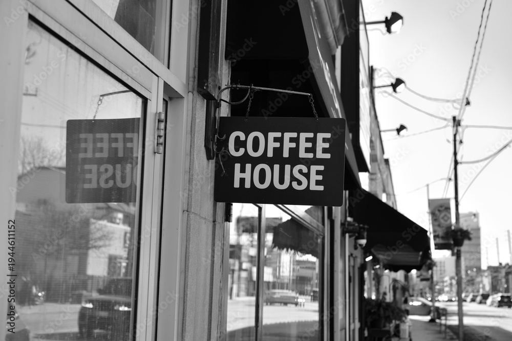 Fototapeta premium wall mounted projecting sign outside Haute Coffee, an espresso bar, located at 153 Dupont St, Toronto