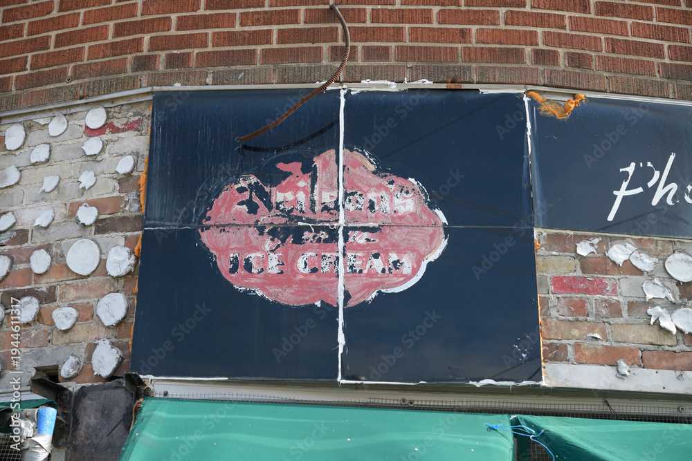Fototapeta premium vintage mid-century painted storefront sign of Neilson's Ice Cream on the front of Convenience / kiosco at 342 Donlands Av, East York, Toronto
