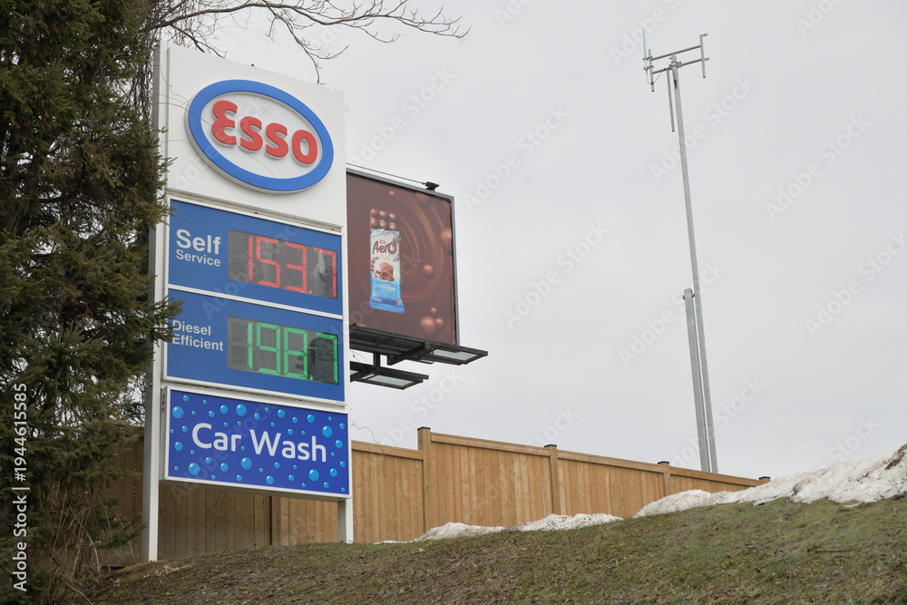 Fototapeta premium Esso gas station roadside pylon sign and fuel price display at 1070 Millwood Rd, East York, Toronto