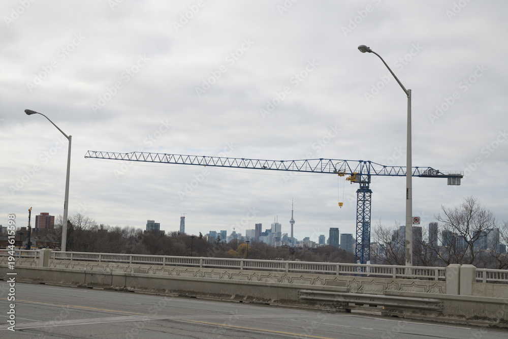 Fototapeta premium construction crane (with EBC Inc sign) near Leaside Bridge, East York, Toronto
