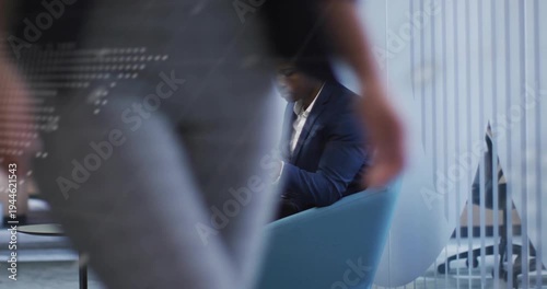 Typing and checking man in blazer on laptop, smartphone in lounge glass map passerby obscuring view