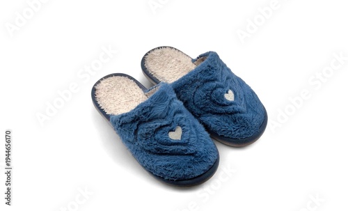 Top view of a pair of soft blue fluffy house slippers with warm fleece lining and small heart detail, isolated on white background.