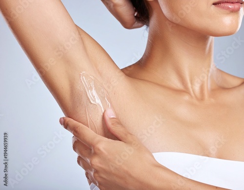 Detail of a woman applying smooth, clear cooling gel to her underarm for skincare. Great for laser therapy, hair removal, or hygiene topics. Minimalist style for beauty and wellness branding.