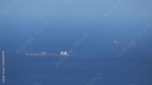 Two Cargo Ships Crossing Open Ocean - Telephoto Maritime Shipping Scene