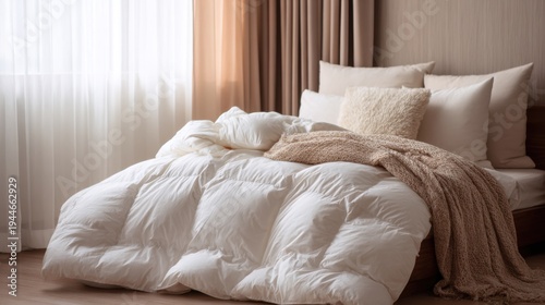 Fluffy white down comforter on bed with beige throw blanket, pillows. Soft, cosy bedding creates tranquil, dreamy atmosphere for ultimate relaxation, sleep
