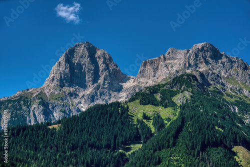 Rugged peaks of the Hochkönig massif with dense coniferous forest in the foreground, Salzburg, Austria