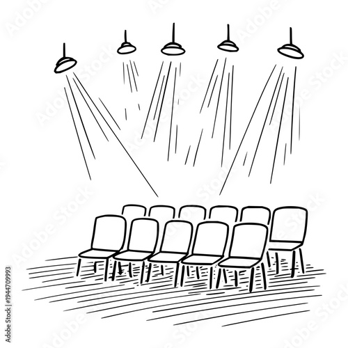 Empty Chairs Under Stage Lights in Theater