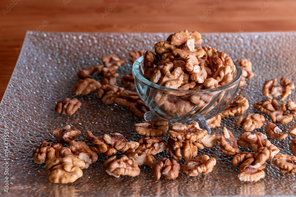 Obraz premium peeled walnut halves in a glass bowl