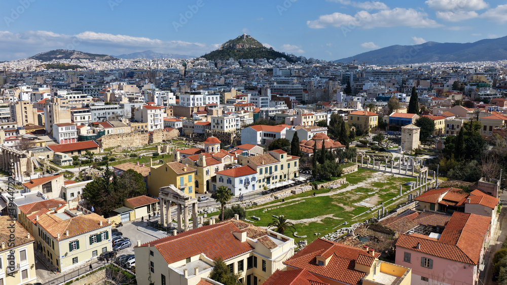 Naklejka premium Aerial drone portrait photo of ancient Roman Market featuring tower of Winds and Gate of Athena in the heart of Athens historic centre built in Plaka district, below Acropolis hill, Attica, Greece