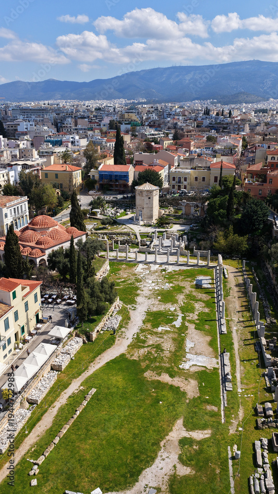 Obraz premium Aerial drone portrait photo of ancient Roman Market featuring tower of Winds and Gate of Athena in the heart of Athens historic centre built in Plaka district, below Acropolis hill, Attica, Greece