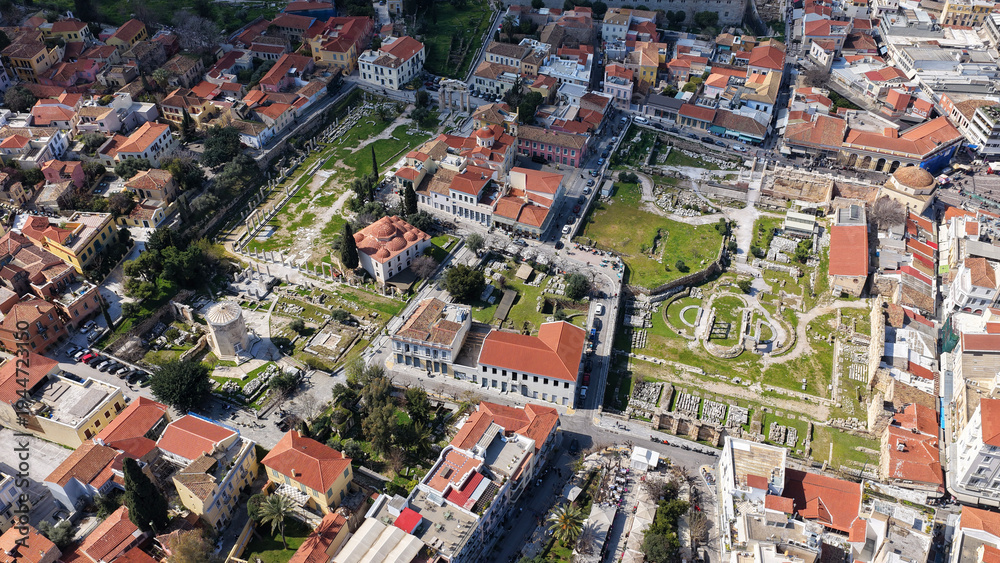 Obraz premium Aerial drone portrait photo of ancient Roman Market featuring tower of Winds and Gate of Athena in the heart of Athens historic centre built in Plaka district, below Acropolis hill, Attica, Greece