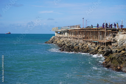 Construction work on a new pier on Iracema beach, with numerous vendor stalls and other amenities for beachgoers. Fortaleza - Ceará, Brazil.