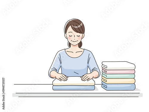 Woman Folding Laundry with Stacked Towels Nearby.