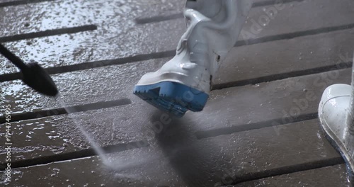 Washing work boots with power hose water jet spray farm factory hygiene safety bio security