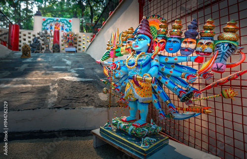 Obraz na plátně Colorful statue of Hindu deity with multiple arms and faces, adorned with intric