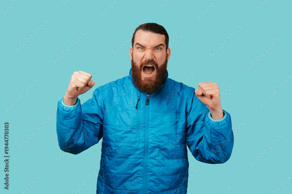 Fototapeta premium Bearded White Man Celebrating Raised Fists, Open Mouth And Intense Expression, Victory Reaction Suggesting