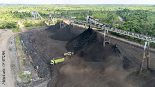 Drone footage from a coal mining site in South Kalimantan shows trucks and heavy equipment in action