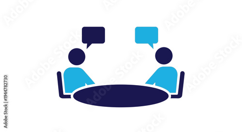 Two people talking at a table.