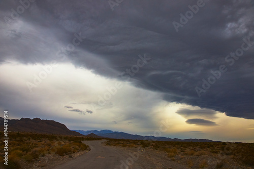 Fotografija Storm Clouds Over Desert Road and Mountains Nevada United States