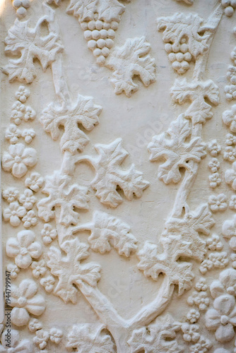 Fragment of a wall with a vine in a mountain monastery