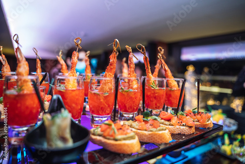 Shrimp tempura appetizers and salmon bruschettas served at a luxury banquet party