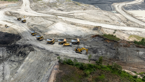 Obraz na płótnie Drone footage from a coal mining site in South Kalimantan shows trucks and heavy