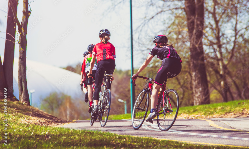 Naklejka premium Cyclists ride on the bike path in the city Park 