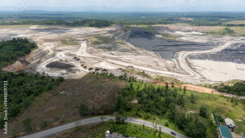 Foto Drone footage from a coal mining site in South Kalimantan shows trucks and heavy