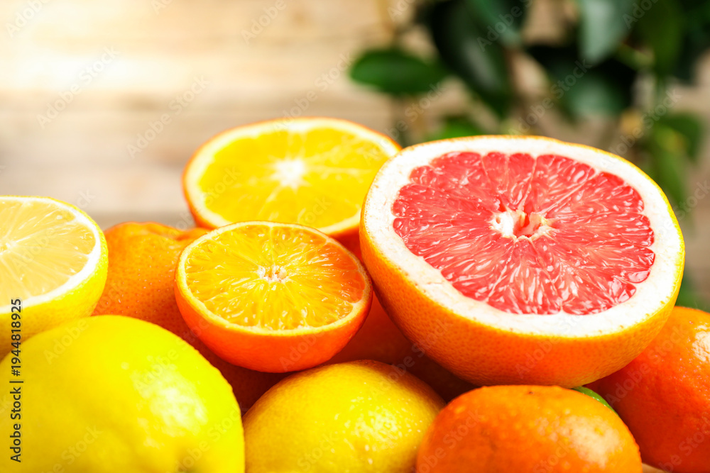 Fototapeta premium Different ripe citrus fruits against blurred background, closeup