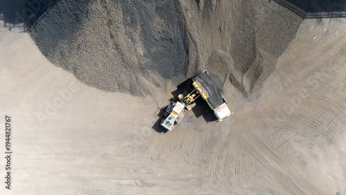 Foto Drone footage from a coal mining site in South Kalimantan shows trucks and heavy