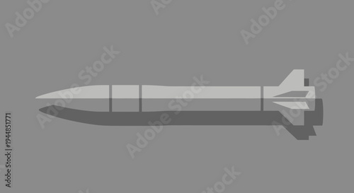 A detailed side view of a grey missile or rocket with fins against a plain background.