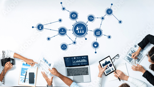Foto A dynamic business meeting scene featuring a collaborative team analyzing data graphics on digital devices, showcasing a modern workspace with innovative technology